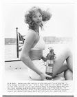 Angel Tompkins holding a fire extinguisher while promoting the U.S. Coast Guard Auxiliary